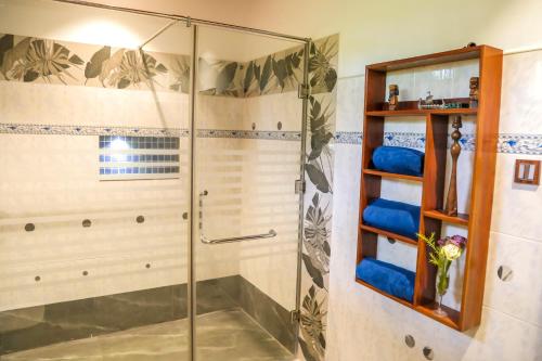 a shower with a glass door in a bathroom at Lullaby Marine Villa in Wadduwa