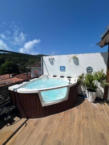 a jacuzzi tub on the deck of a house at Casa Macao Pipa in Pipa