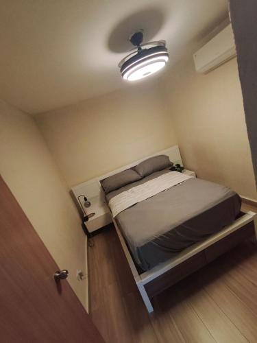 a small bed in a small room with a light at Quiet place in El Seis
