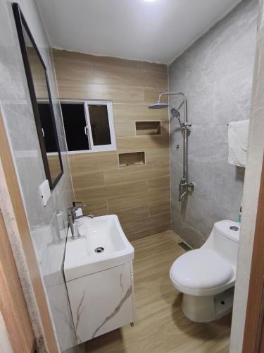 a bathroom with a sink and a toilet and a shower at Quiet place in El Seis