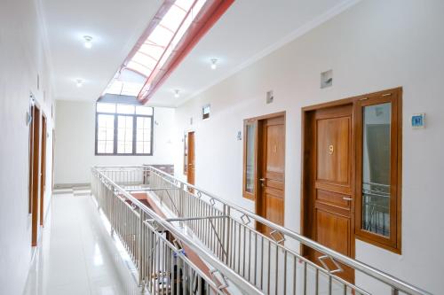 a hallway of an empty building with a skylight at RedDoorz at Syariah House Purwokerto in Purwokerto