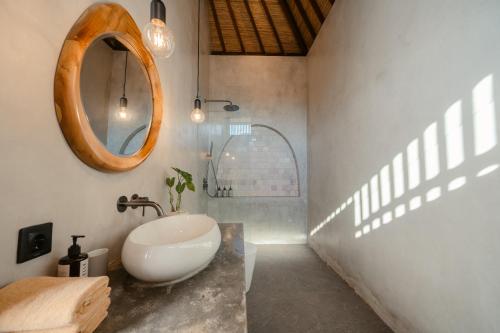 a bathroom with a sink and a mirror at Casa Nova Villa Uluwatu in Uluwatu