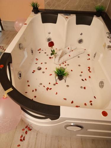 a bathtub filled with flower petals on the floor at AL NAHAR AL KHALEd in Aqaba