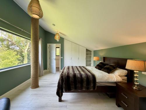a bedroom with a large bed and a large window at Property 525 - Galway in Moycullen