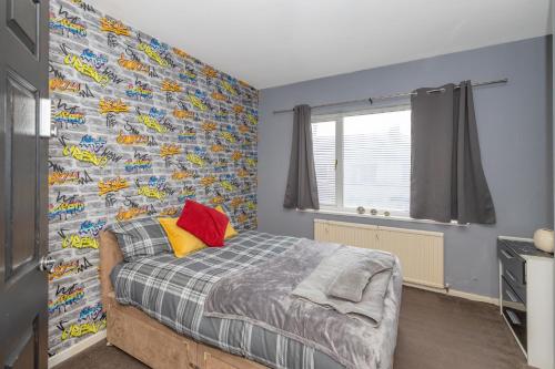 a bedroom with a bed and a wall covered in race cars at Billingham Rooms in Stockton-on-Tees