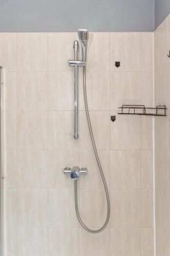a shower with a shower head in a bathroom at Billingham Rooms in Stockton-on-Tees