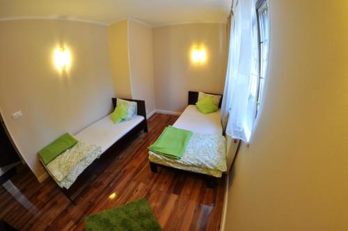 a small room with two beds and a window at Willa Kalinowa in Sopot