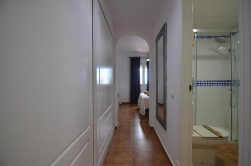 a bathroom with a toilet and a glass shower at La Marina Solmares in Isla del Moral