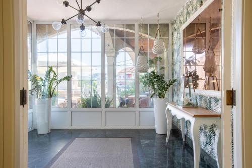a room with a large window and a table with plants at San Marcos Salnés in Cambados
