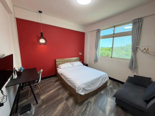 a bedroom with a bed and a desk and a window at Little Weekend Inn in Jincheng