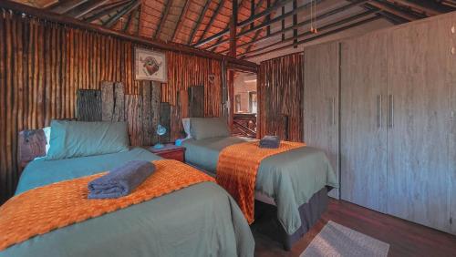 a bedroom with two beds in a room at Mahlolwa in Marloth Park