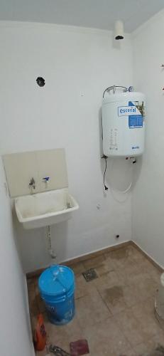 a bathroom with a sink and a washing machine at Depto Rafaela in Rafaela