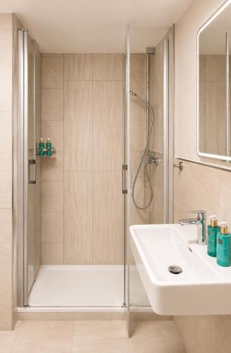 a bathroom with a shower and a sink at Boutique Hotel Marielle in Bad Münstereifel