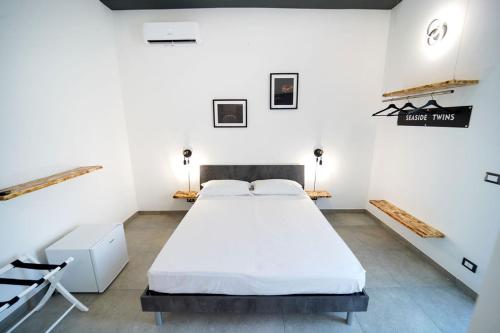 a bedroom with a large white bed in a room at SEASIDE TWINS b&b in Fragagnano