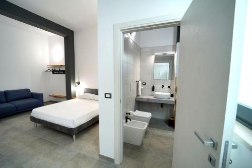 a bedroom with a bed and a bathroom with a sink at SEASIDE TWINS b&b in Fragagnano