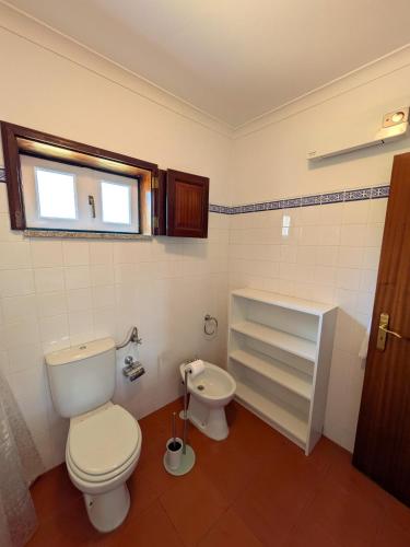 a bathroom with a toilet and a sink at Casa da Sofia in Ponte da Barca