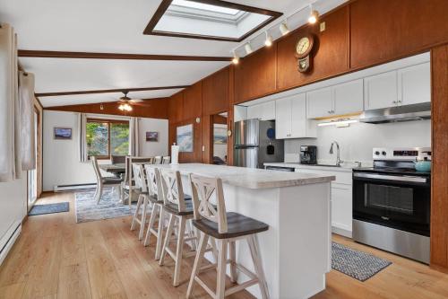 a kitchen with a large island with bar stools at Egg Harbor Waterfront home in Egg Harbor