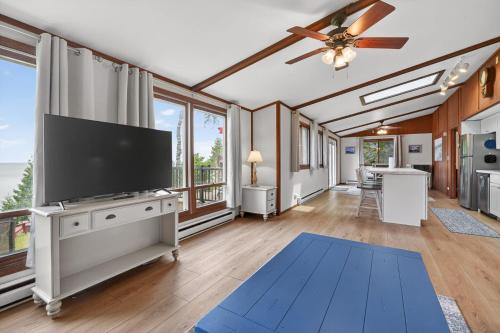 a living room with a large flat screen tv at Egg Harbor Waterfront home in Egg Harbor
