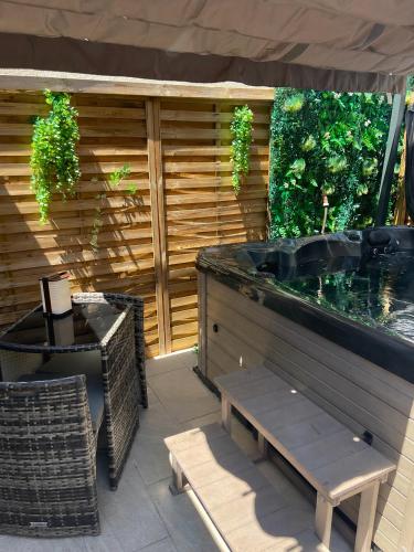 a patio with a fish tank and a bench at Cabane insolite avec jacuzzi in Menton