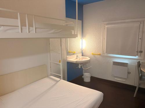 a small room with a bed and a sink at Unisotel GAP -" Ex HôtelF1" in Gap