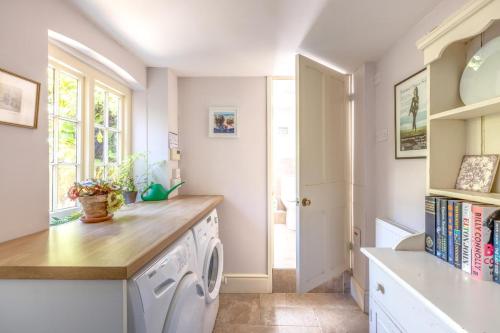 a laundry room with a washer and dryer at 3 Bed in Bridport oc-dc160 in Bridport