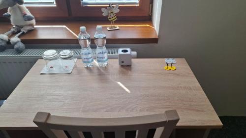 a wooden table with water bottles on top of it at Ubytování U Včelek in Horní Dubňany