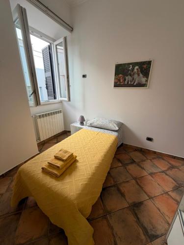a bedroom with a bed with two towels on it at Bouganville House in Nettuno