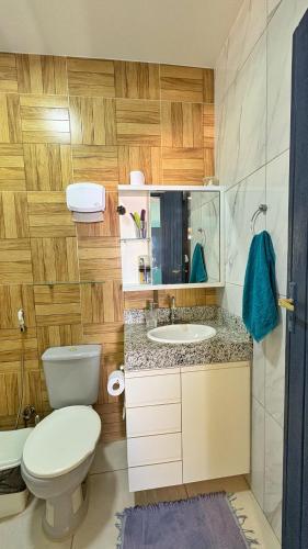 a bathroom with a toilet and a sink at Xodó da Lagoa in Beberibe
