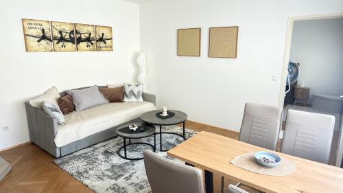 a living room with a couch and a table at Apartment Niki in Siegendorf im Burgenland