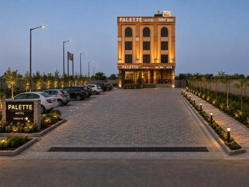 a parking lot in front of a building at Palette Hotel by CheckIn Amritsar, Airport Road in Amritsar