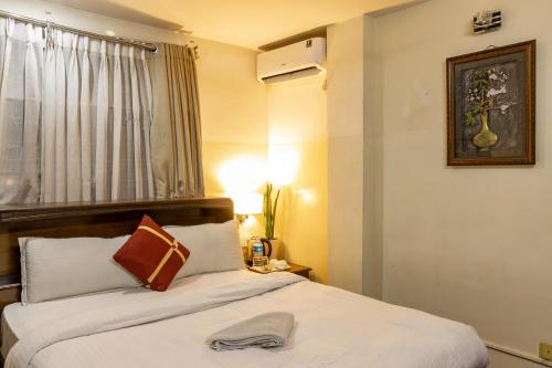 a hotel room with a bed with a hat on it at Hotel Swastik in Kathmandu