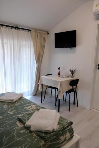 a room with a table and a television on the wall at The View in Satu Nou de Sus