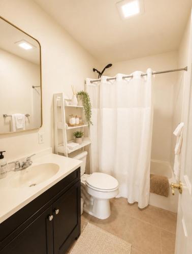a bathroom with a white toilet and a sink at Ojai Pixie House in Ojai