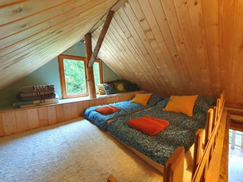 a bedroom with two beds in a attic at Ostaya - Mountain Cottage in Obidza