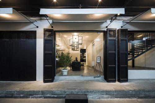 an open door of a building with a potted plant at Sala Rattanakosin Bangkok in Bangkok