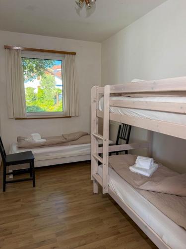 a room with two bunk beds and a window at Res Roncaccio, Cancro by HolAp SA in Vairano