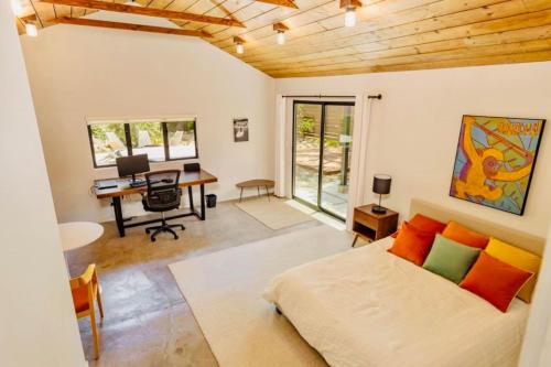 a bedroom with a bed and a desk with a computer at Downtown Ojai Gem in Ojai