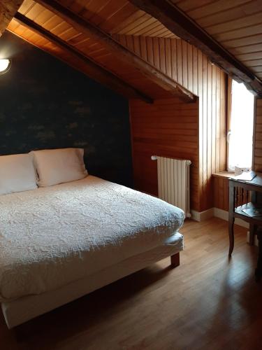 a bedroom with a bed and a window at Auberge des Volcans in Saint-Chamant