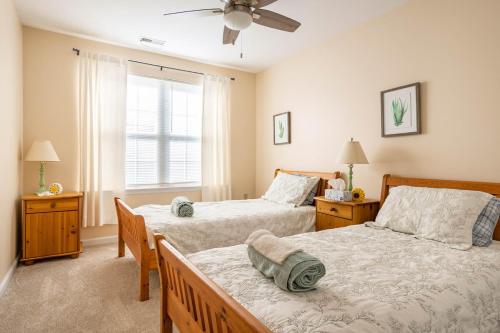 a bedroom with two beds and a window at CoastalBoho-Spacious 4BDtownhouse 3 mi from beach in Rehoboth Beach