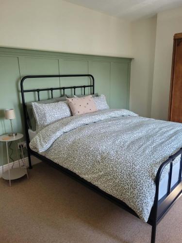 a bedroom with a bed with a metal frame and pillows at Brent Top in Penrith
