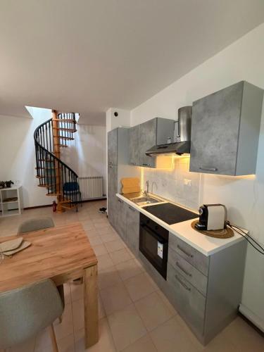 a kitchen with a table and a counter top at Riva Bianca in Ameglia