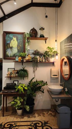 a bathroom with a bunch of plants on the wall at SEMERU HOSTEL MALANG in Malang