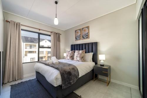 a bedroom with a bed and a large window at #AlimamaSpaces The Contemporary Retreat in Midrand