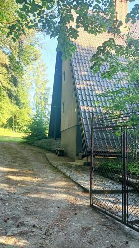 a building with a fence in front of it at Pogórzański Domek in Ciężkowice