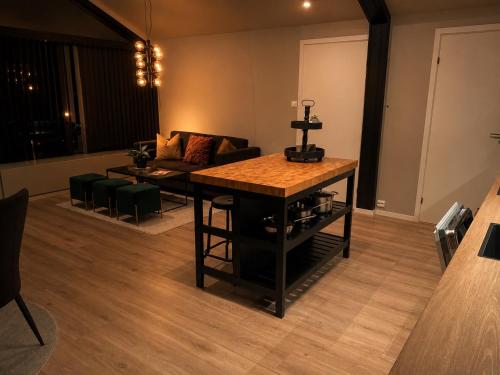 a living room with a table and a couch at Reine City Apartment in Reine