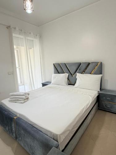 a bedroom with a large bed with white sheets at casa jihan playa TGV in Tangier