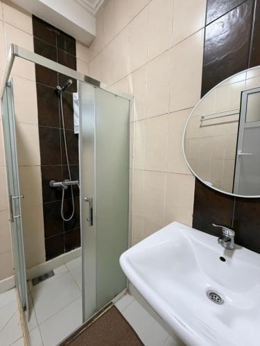 a bathroom with a shower and a sink and a mirror at casa jihan playa TGV in Tangier