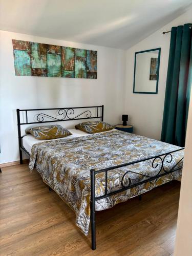 a bedroom with a bed in a room with green curtains at MARANGUN Drage apartman in Drage