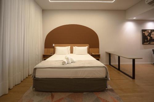 a bedroom with a bed with a white towel on it at Village Rio Hotel in Chavantina