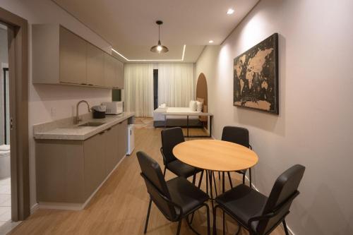 a kitchen and dining room with a table and chairs at Village Rio Hotel in Chavantina